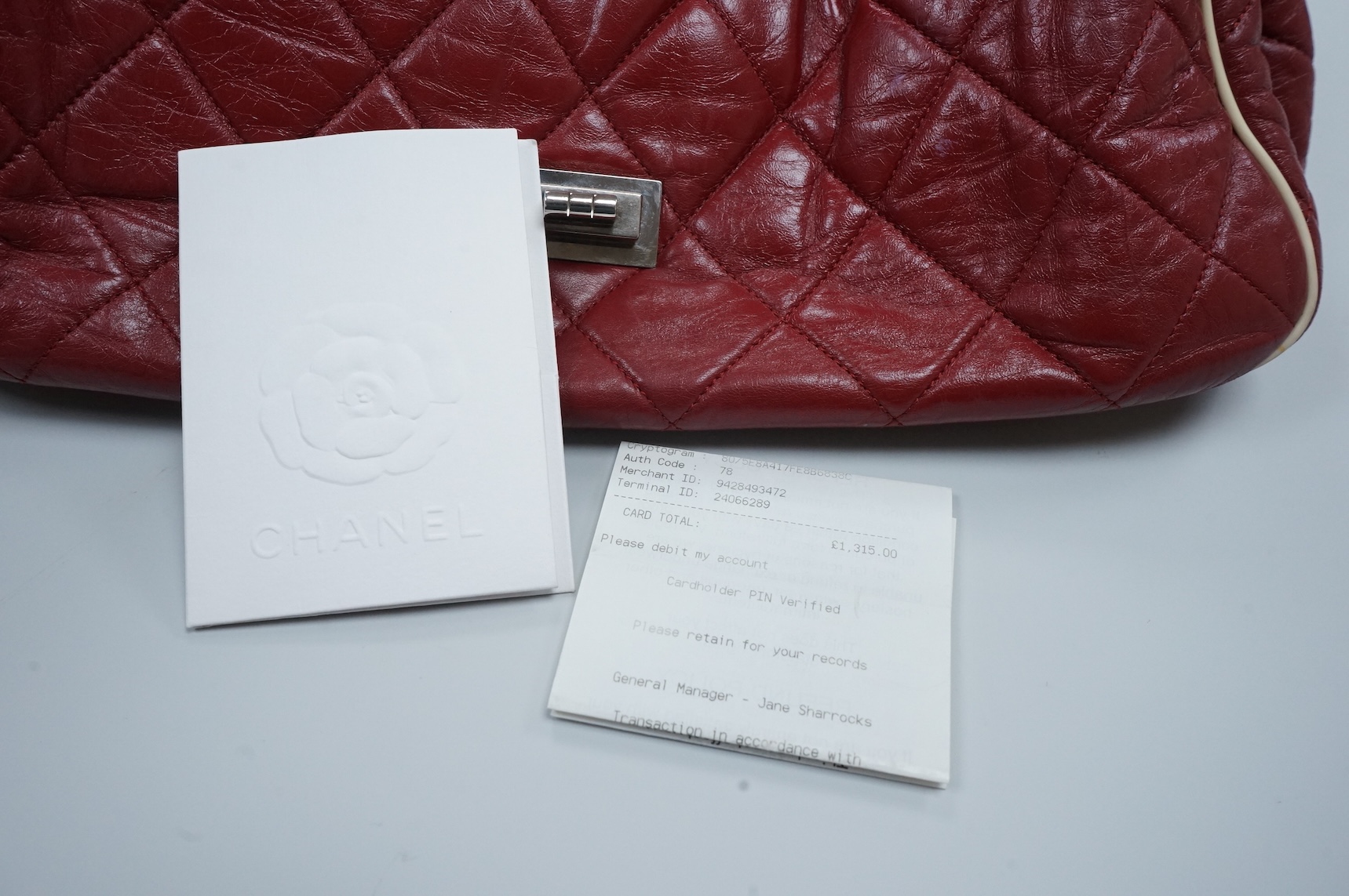 A Chanel East West dark red quilted leather flap shoulder bag with silver hardware, date code 12115484, with original receipt, dust cover and box, 35cm wide, Provenance: purchased by the vendor in Selfridges